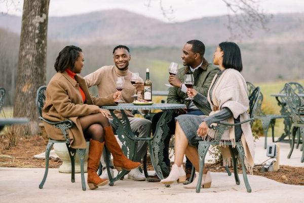 friends drinking wine outdoors during winter