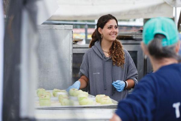 a woman with a tray of peeled apples