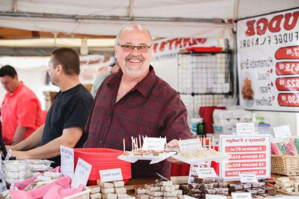 a smiling vendor at the Apple Festival