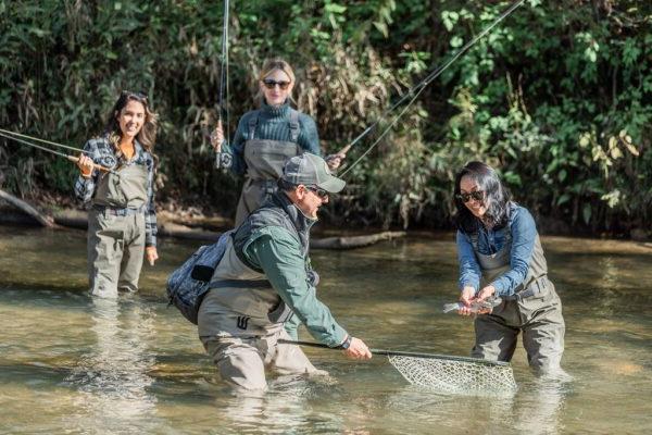 a group of friends catching a fish