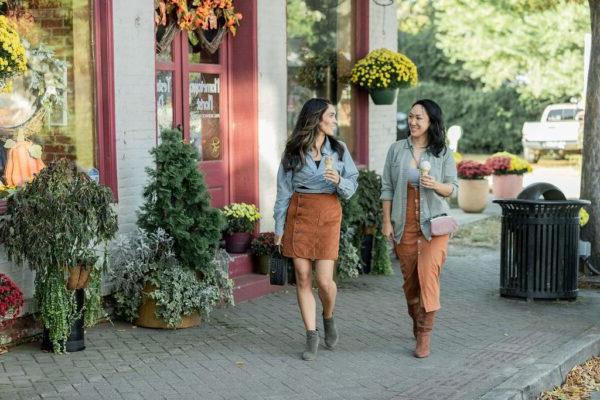 women walking and enjoying ice cream in the fall