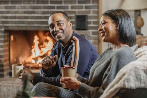 friends enjoying hot cocoa by a fire