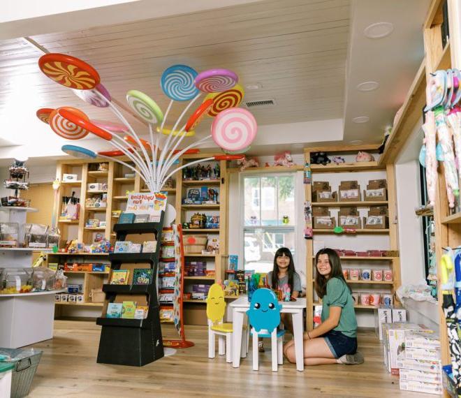 children at a small table surrounded by candy