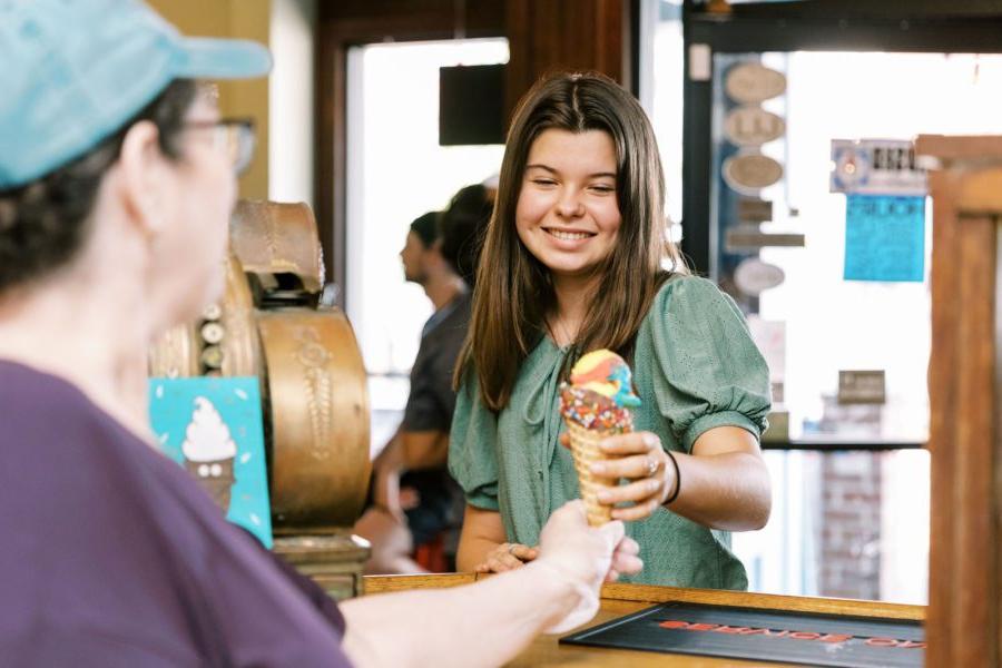 a woman holding an ice-cream cone