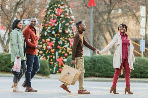 friends walking outside with Christmas decorations